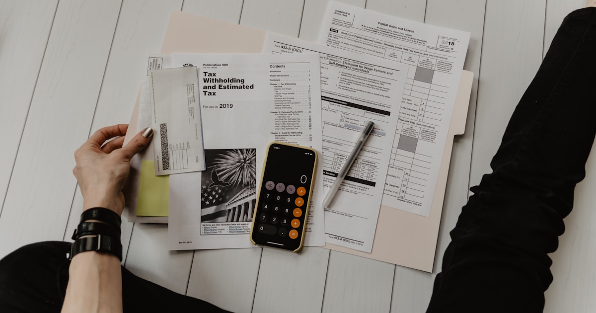 A notebook with budget planning notes and a pen